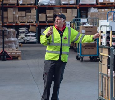 Green Fulfilment Employee Working in Warehouse