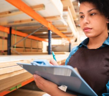 Young Woman Doing Inventory In Warehouse