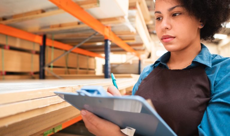 Young Woman Doing Inventory In Warehouse