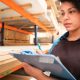 Young Woman Doing Inventory In Warehouse