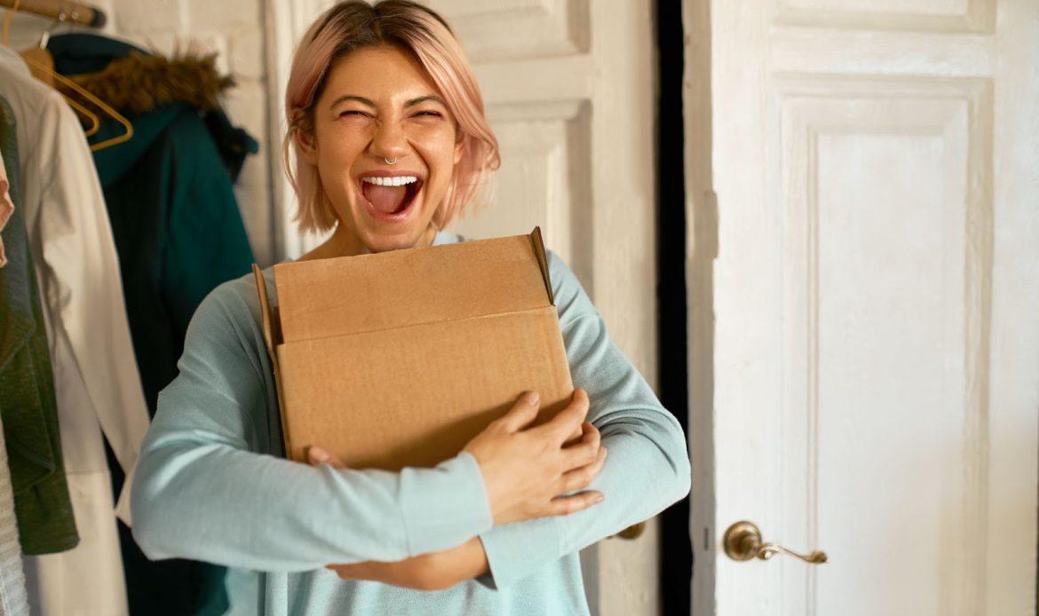 Young Woman Showing Happiness While Holding Her Package