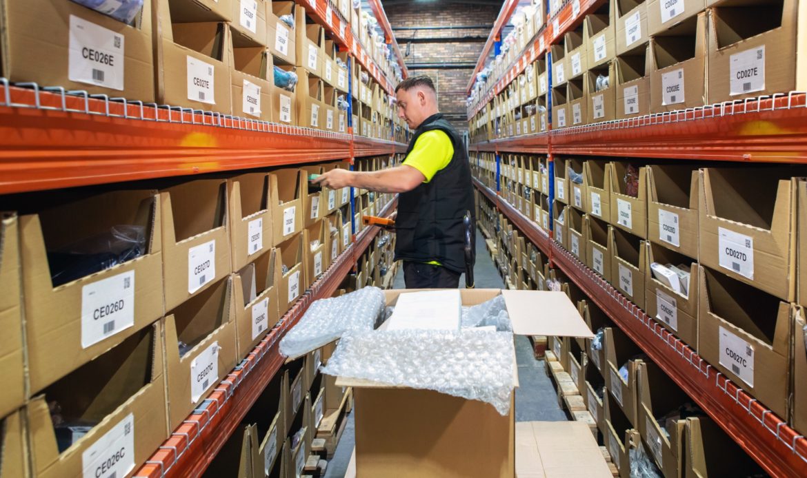 Young Man Sorting Products on Warehouse